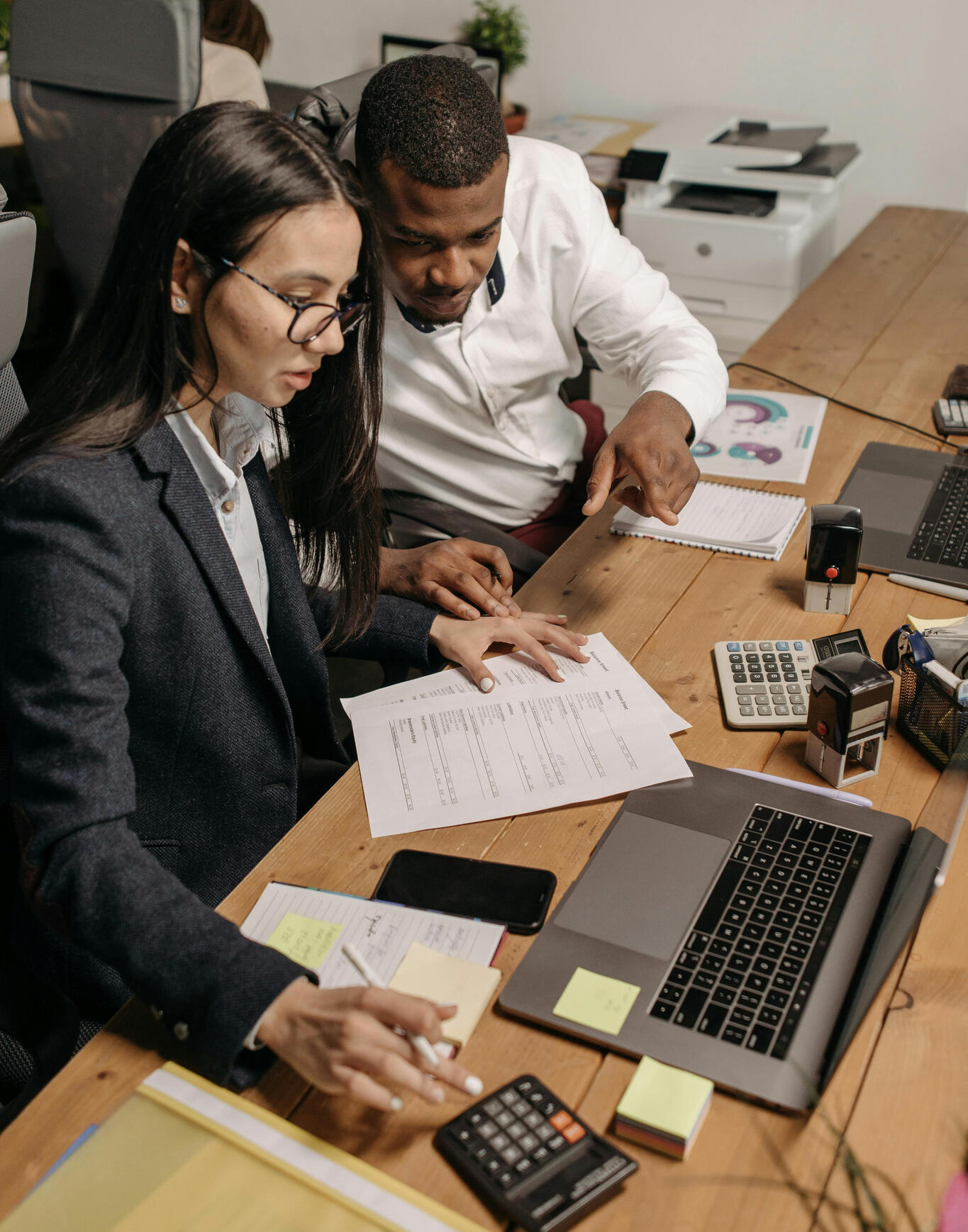 Business owners reviewing programs to save money and retain employees